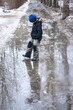 © Anton Barashenkov - Boy playing in winter puddle