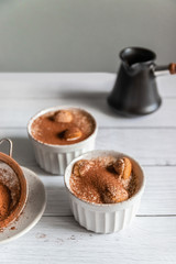 Wall Mural - Delicious classic tiramisu in a jar on a gray background.