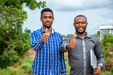 Wall Mural - two young african business man giving the thumbs up gesture