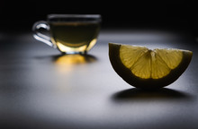 One Slice Of Lemon On The Background Of A Cup Of Tea A Dark Gloomy Background. A Warming Vitamin Drink For Colds And Flu
