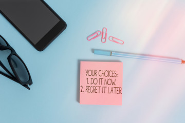 Wall Mural - Writing note showing Your Choices 1 Do It Now 2 Regret It Later. Business concept for Think first before deciding Eyeglasses colored sticky note smartphone cell pen pastel background