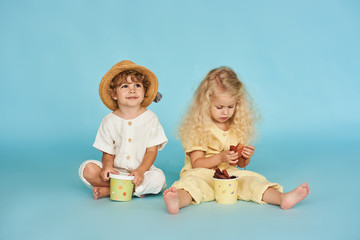 Two little boy and girl in with paper boxes. Design and advertising idea for packaging.