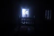 © zef art - Old creepy eerie baby crib near window in dark room. Scary baby silhouette in dark. A realistic dollhouse living room with furniture and window at night