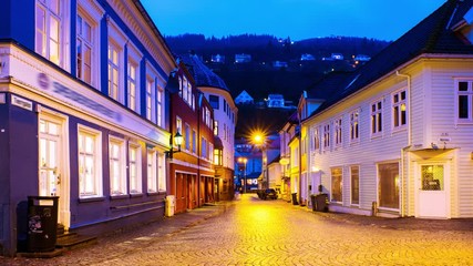 Wall Mural - Bergen, Norway. View of old historical fishermen houses in Bergen, Norway during the sunrise. Time-lapse of empty streets in the morning after the rain