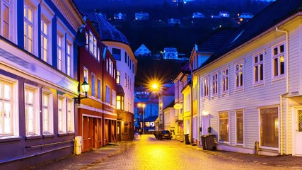 Wall Mural - Bergen, Norway. View of old historical fishermen houses in Bergen, Norway during the sunrise. Time-lapse of empty streets in the morning after the rain, panning video