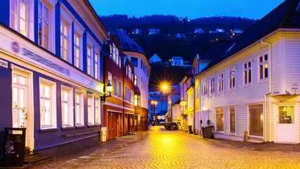 Wall Mural - Bergen, Norway. View of old historical fishermen houses in Bergen, Norway during the sunrise. Time-lapse of empty streets in the morning after the rain, zoom in