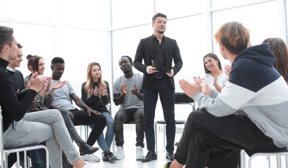 Wall Mural - speaker standing in a circle of business training listeners