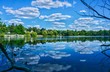 Nice view to the Hundekehlesee in Berlin-Grunewald. The clouds of the summer sky are reflected in the water of the lake.