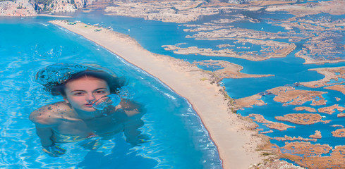 Wall Mural - Young girl swimming in Blue Lagoon of Iztuzu beach next to Mediterranean sea - Iztuzu, Turkey