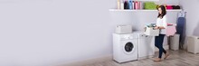 Woman Standing Near Washing Machine With Basket Of Clothes