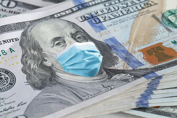 One hundred dollar banknote with face mask, closeup