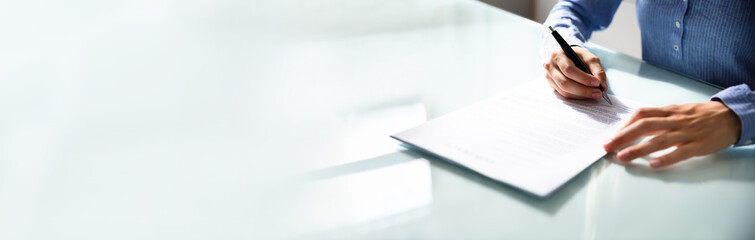 businesswoman's hand signing contract