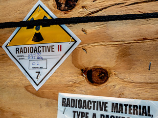 Poster - Radiation label beside the transport wooden box Type A package