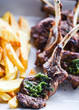 delicious grilled lamb chopsticks with french fries, pesto sauce & mix of lettuces