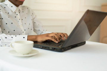 beautiful young african woman with laptop