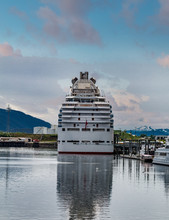 A Massive Luxury Cruise Ship Docked In A Harbor In Alaska