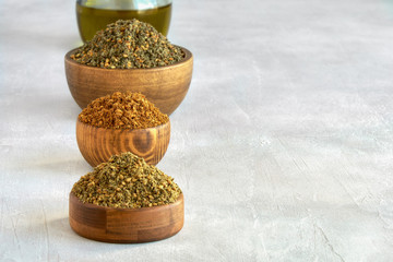 Wall Mural - Mixed spice zaatar or zatar in wooden bowls, Various type of zaatar blend. Close up with copy space