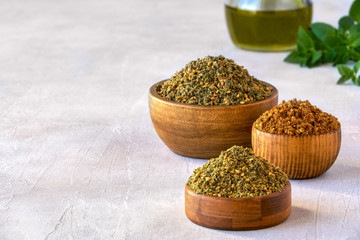 Wall Mural - Mixed spice zaatar or zatar in wooden bowls, Various type of zaatar blend. Close up with copy space