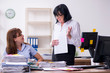 © Elnur - Two female employees and excessive work in the office