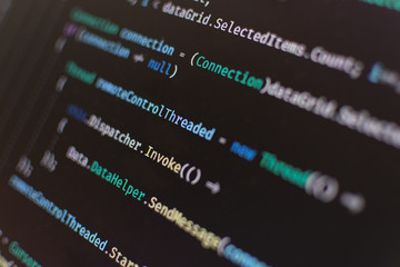 coding a c# project in a computer on a dark mode ide. selective focus.