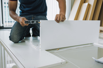 Service man assembling furniture for customer, Delivery service furniture store and assembling for buyer.