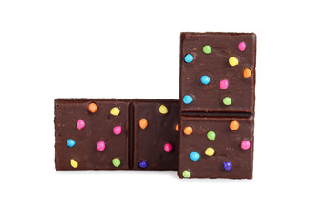 two brownies with colorful candy pieces on white