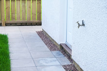 Bib Tap Outdoors On House External Wall To Water Garden And Car