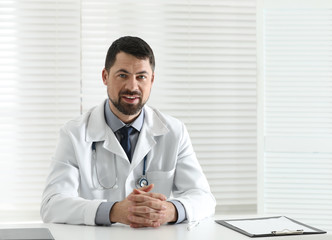 Poster - Portrait of male doctor in white coat at workplace