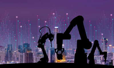 Leinwandbilder - Silhouette of modern automation robot arms with Ai assistant technology network concept and metropolis city building background.