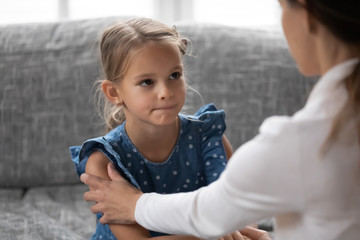 Supporting young mom touch comfort caress upset little preschooler Caucasian daughter having problems, caring mother support show love and understanding talk with sad small girl child at home