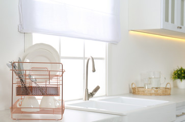 Sticker - Clean dishes on drying rack in modern kitchen interior