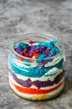Rainbow Cake Dessert In Glass Jar Flavored With Dragee And Fruits.
