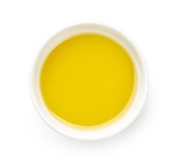 Bowl of olive or vegetable oil isolated on white. Top view of oil.