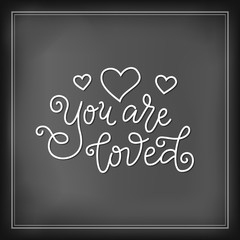 Wall Mural - Modern mono line calligraphy lettering of You are loved in white with hearts on chalkboard