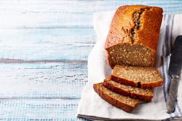 Wall Mural - Healthy vegan oat and banana loaf bread, cake. Blue wooden background. Copy space.