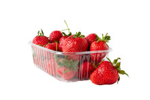 Red Strawberries Laying In Big Plastic Transparent Container And One Big Berry Laying Near The Box Isolated On White Background