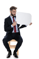 Canvas Print - young businessman looking and presenting speech bubble to side