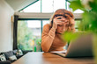 © bnenin - Portrait of a woman facing financial problems, sitting at table with laptop, front view, copy space.