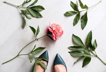 Wall Mural - Woman standing by peony flower and leaves