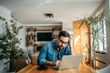 © bnenin - Portrait of a man with troubled face looking at laptop at home office.