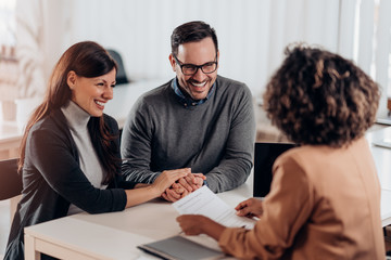 Wall Mural - Couple talking to their insurance agent on a meeting