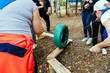 © Anton Eremin - Team building team plays outdoors in summer with a wheel