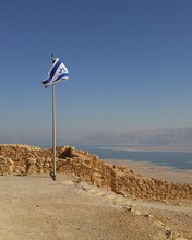 Israeli Flag By Lake Against Clear Blue Sky