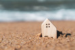 © ant - Buy icon screen on model of a little house  with nature green background. Dream life concept.