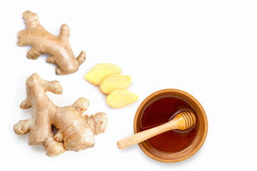 Wall Mural - Closeup fresh organic ginger root with slice and pure honey in wooden bowl isolated on white background.Top view. Flat lay.