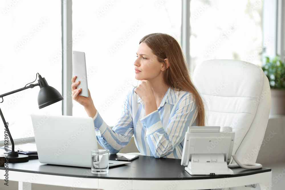 Beautiful young secretary working in office