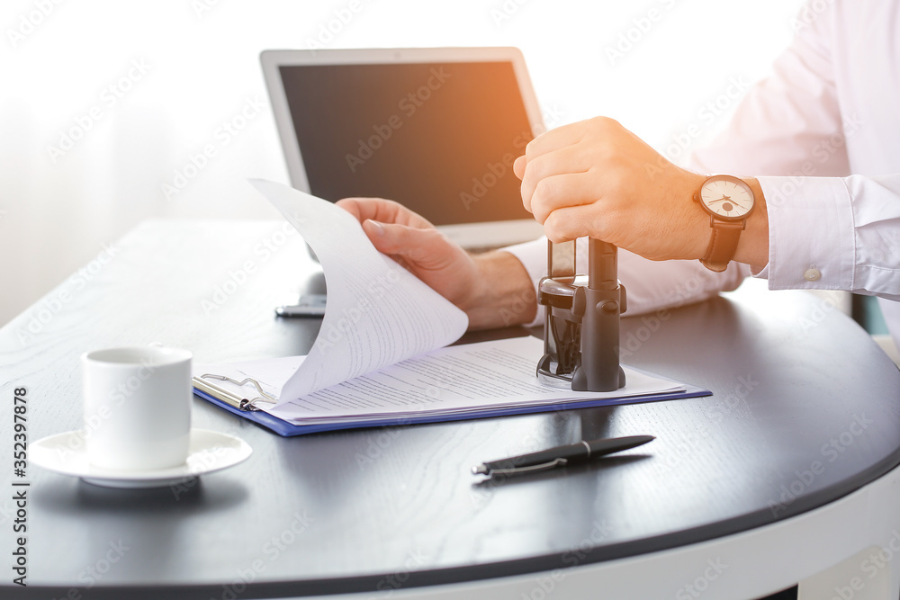 Male lawyer working with document in office