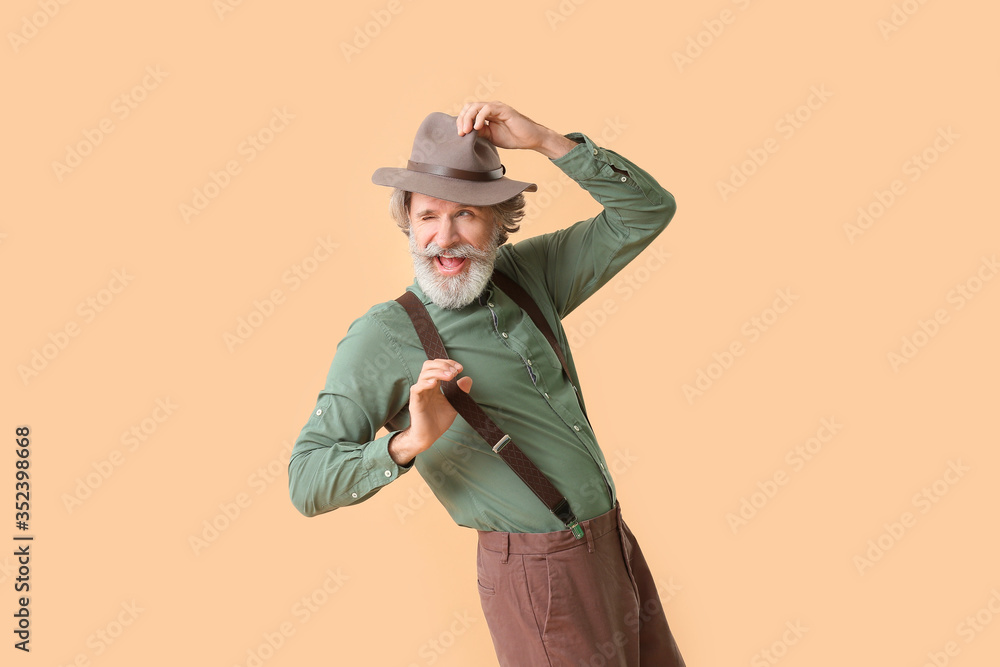 Cool senior man dancing against color background