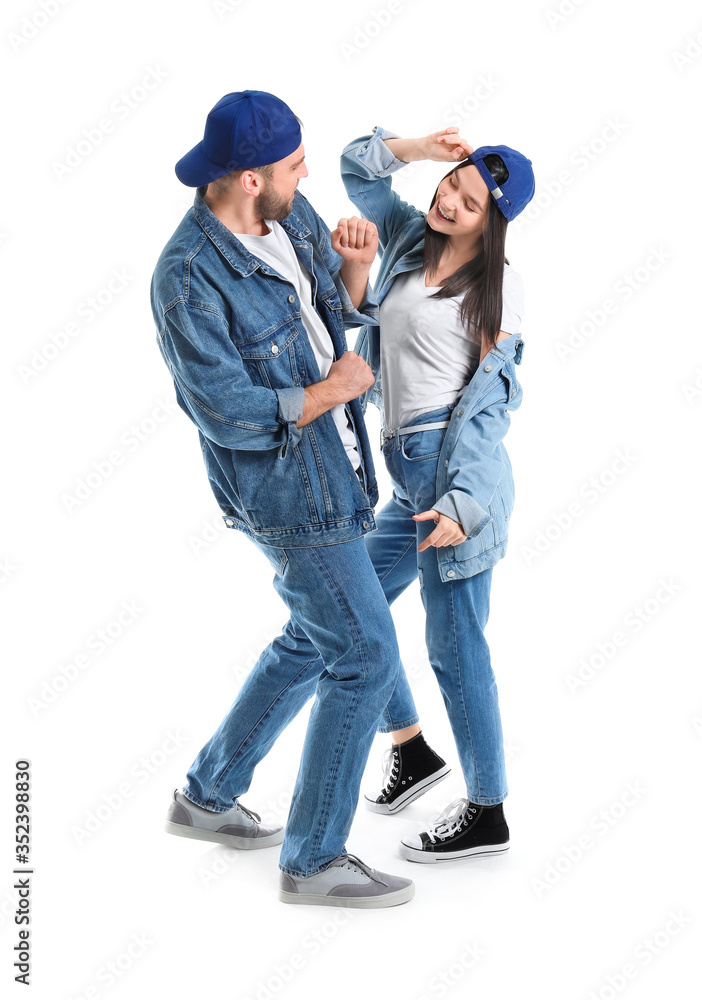Happy young couple dancing against white background