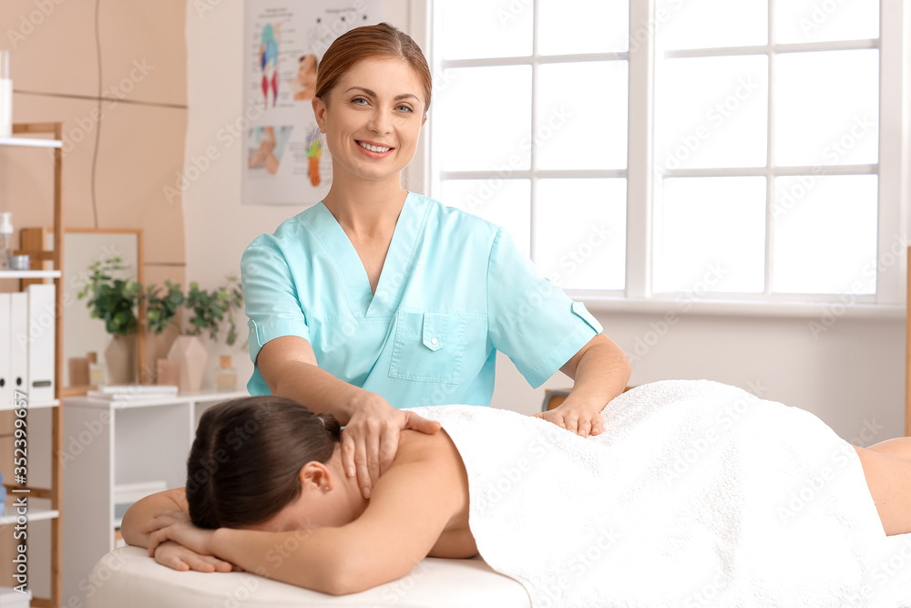 Massage therapist working with patient in medical center